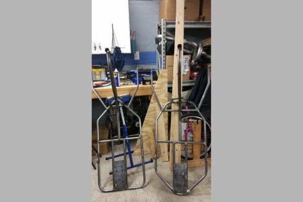 Two metal carts are sitting in a workshop.