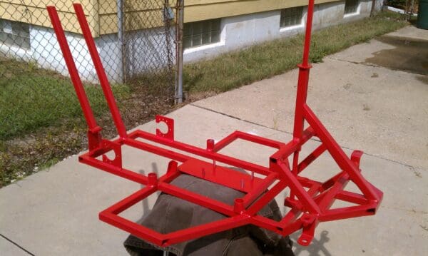 A red frame sitting on top of concrete.