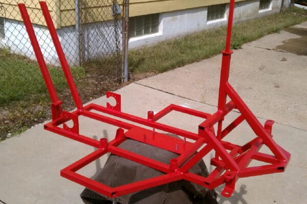 A red frame sitting on top of concrete.