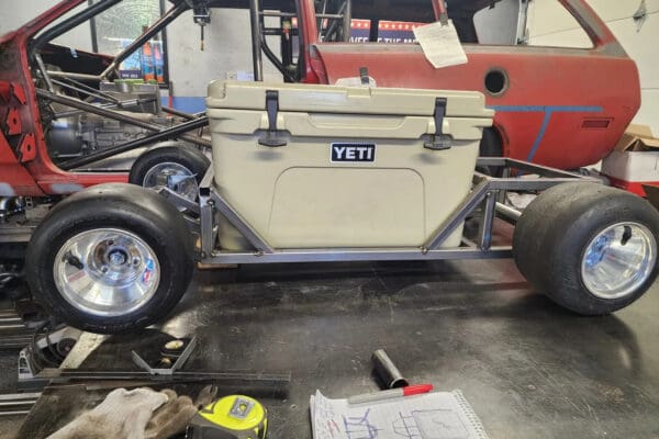 A yeti cooler sitting on top of the back of an off road vehicle.