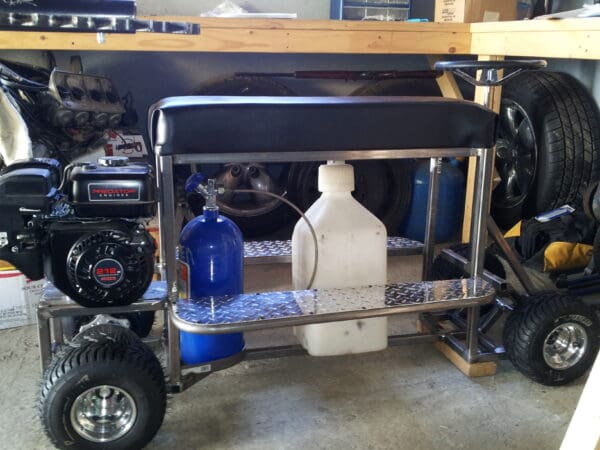 A table with two shelves holding bottles of oil and gas.