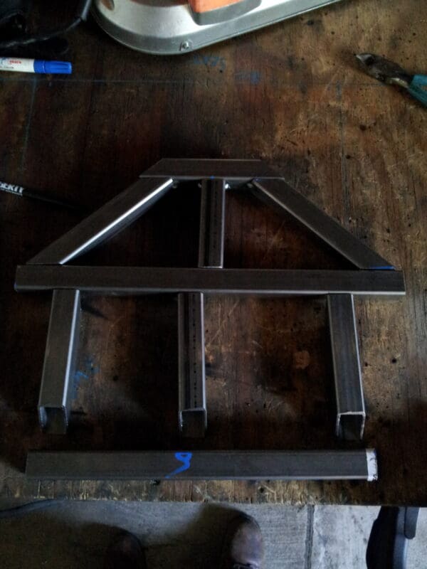 A metal frame sitting on top of a wooden table.