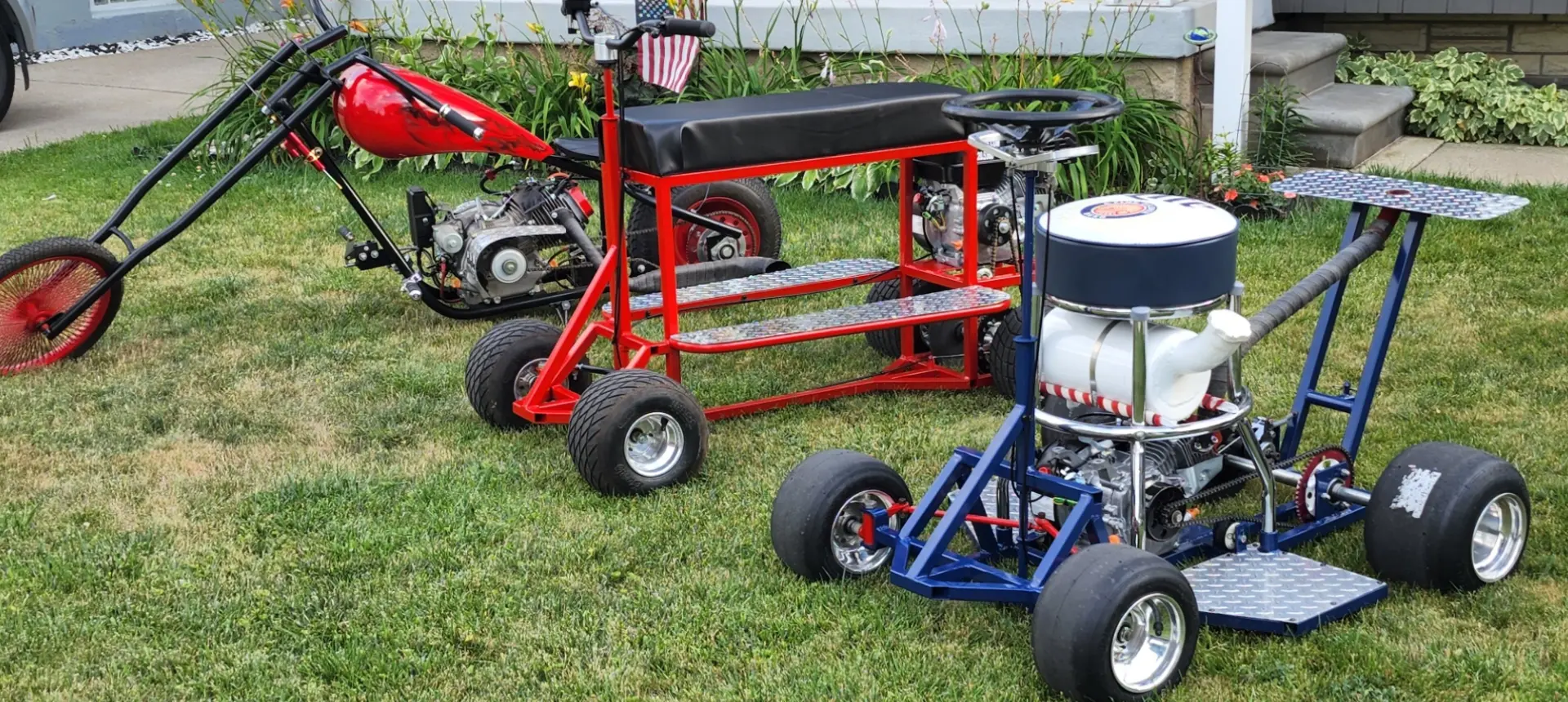 A group of four carts in the grass.