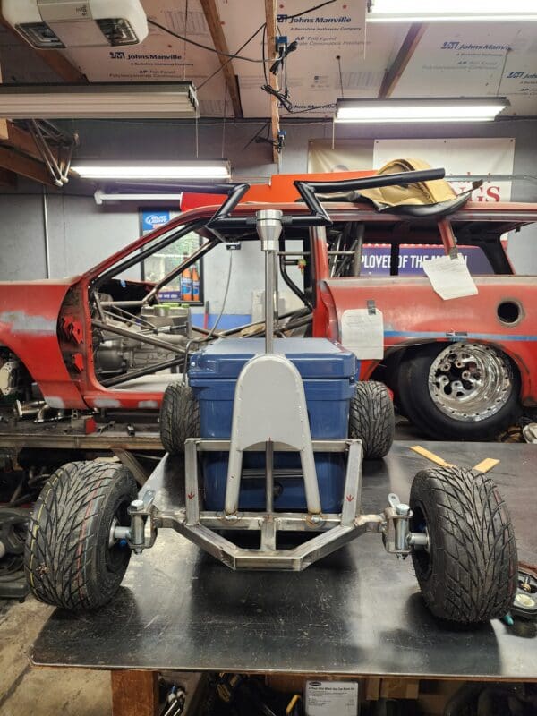 A red truck is parked in the garage