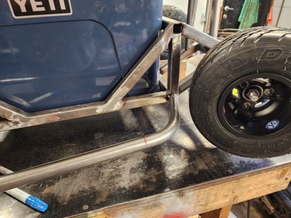 A tire is being worked on the back of a truck.